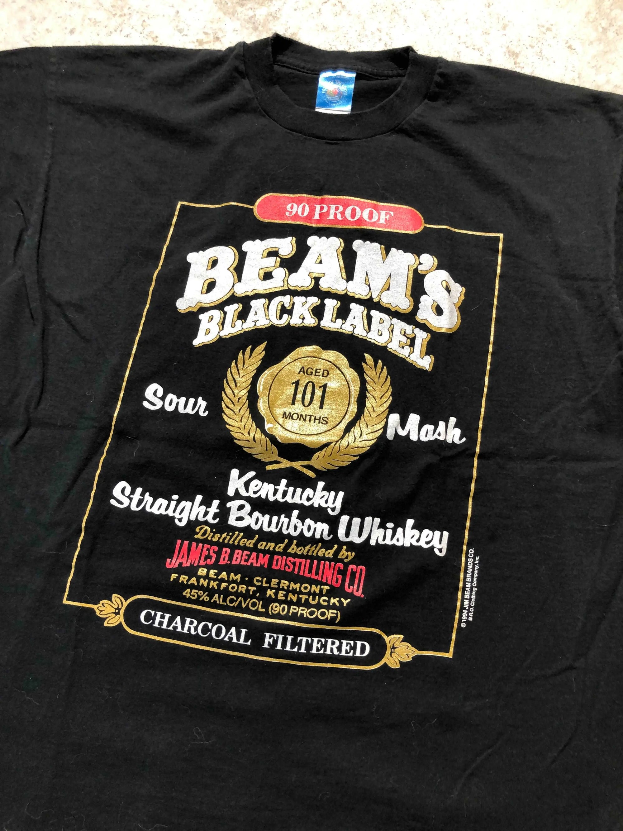 Vintage black X-Large 1994 Jim Beam Black Label Whisky t-shirt with a gold and white label graphic.