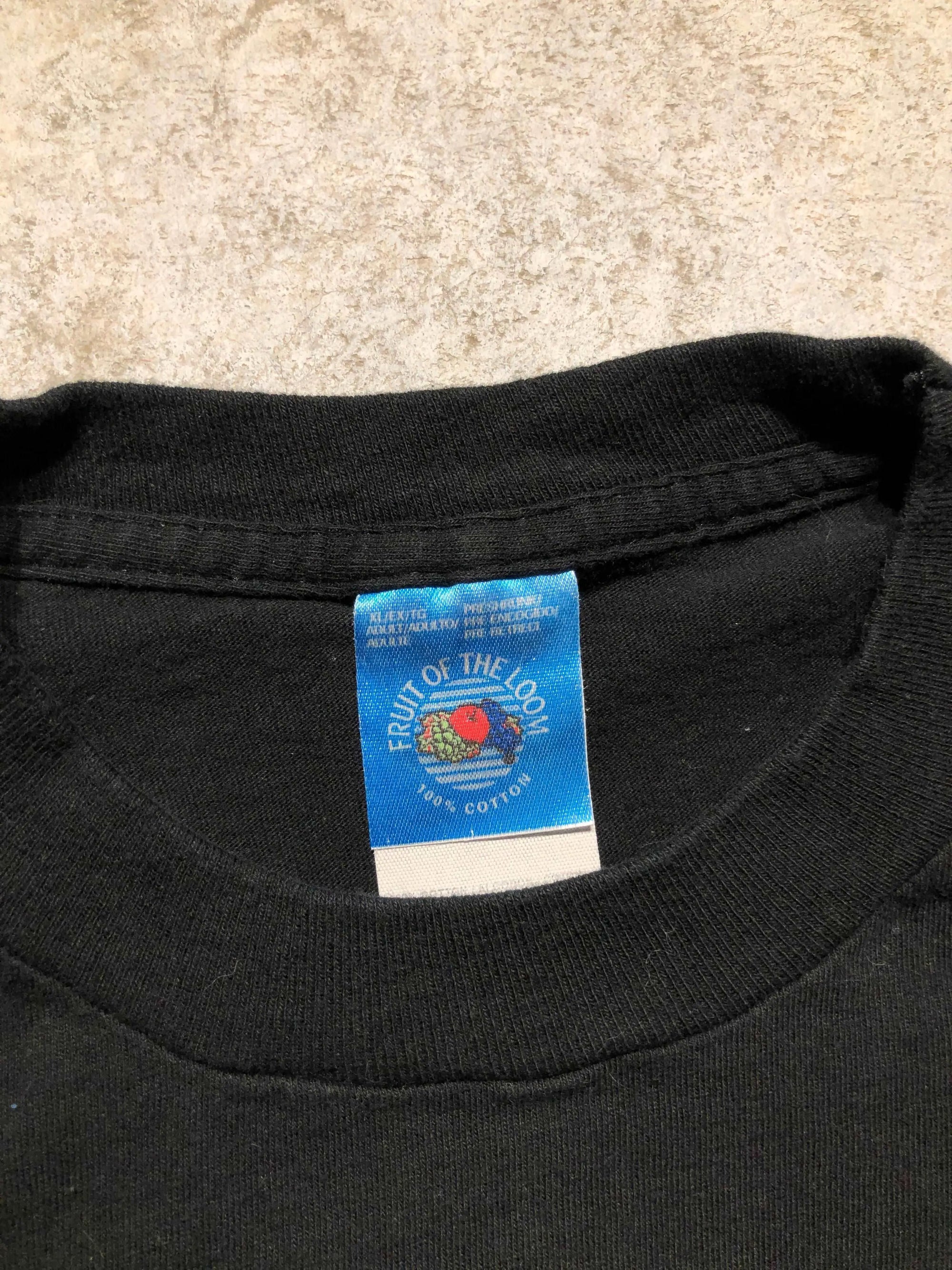 Black vintage Fruit Of The Loom X-Large 100% cotton t-shirt with blue tag.